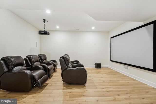 a large bed sitting in a bedroom next to a window and a wooden floor