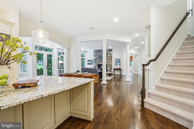 a view of living room with granite countertop furniture and a chandelier