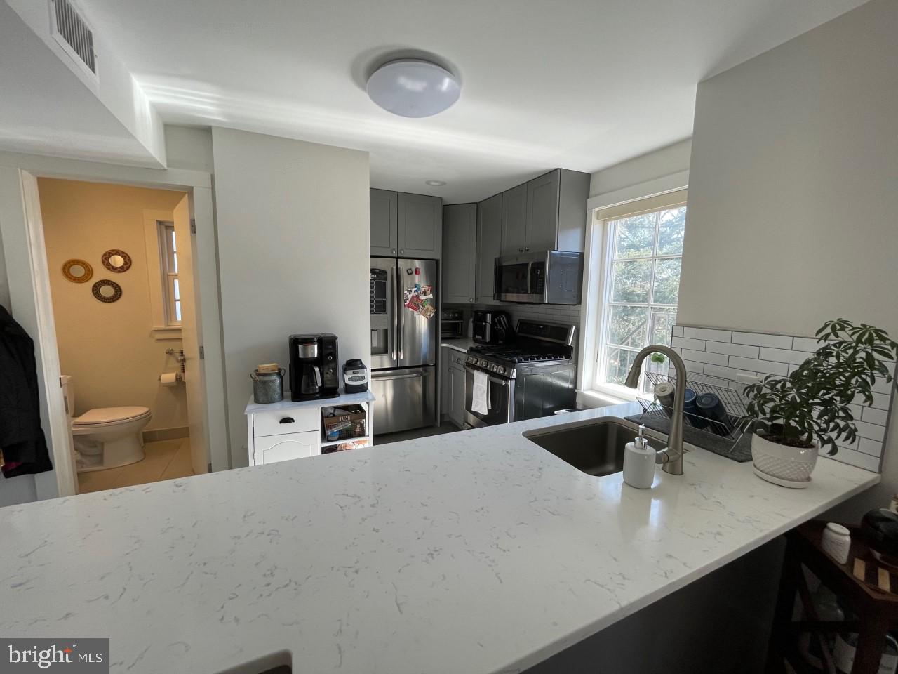 205 Witherspoon Street, Unit 4 Princeton, NJ 08542 - Photo 3 of 11 a kitchen with a sink a stove and chairs