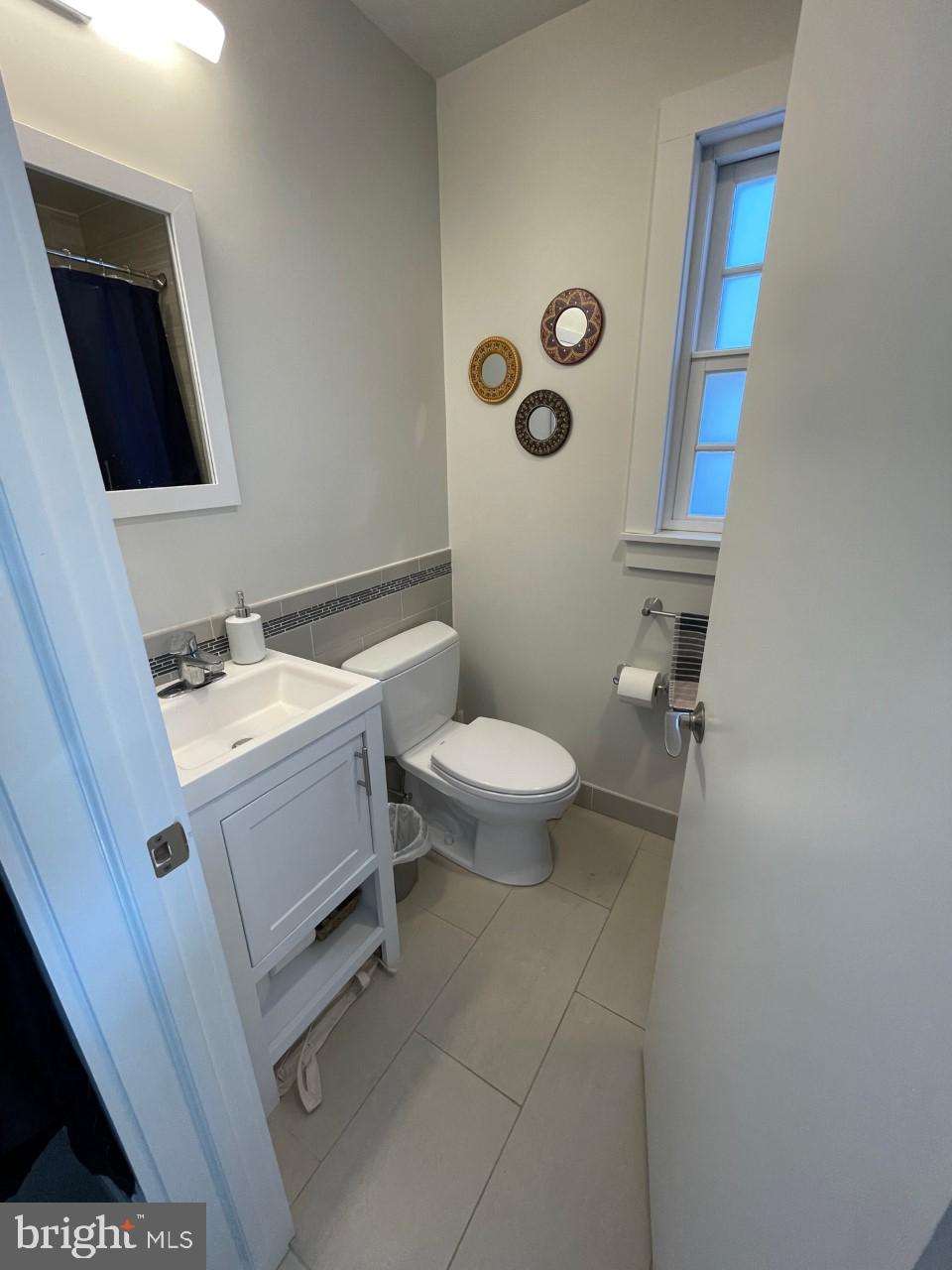 205 Witherspoon Street, Unit 4 Princeton, NJ 08542 - Photo 5 of 11 a bathroom with a toilet a sink and mirror