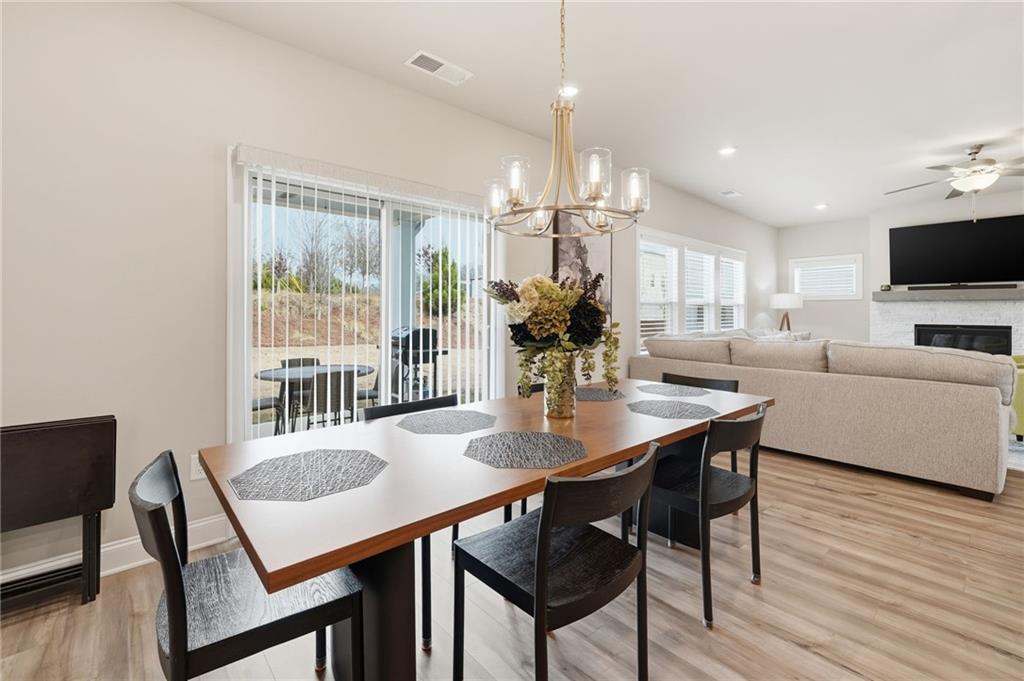 515 Cobblestone Circle Canton, GA 30115 - Photo 11 of 45 a view of a dining room with furniture window and wooden floor