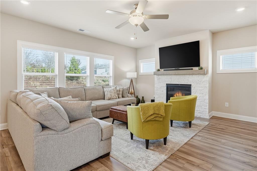 515 Cobblestone Circle Canton, GA 30115 - Photo 12 of 45 a living room with furniture fireplace and a flat screen tv
