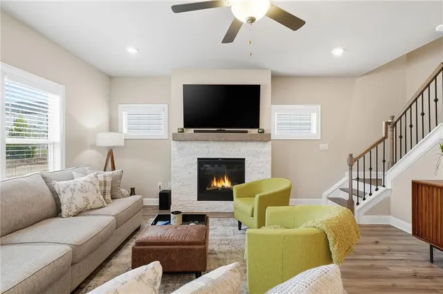 a living room with furniture kitchen view and a chandelier