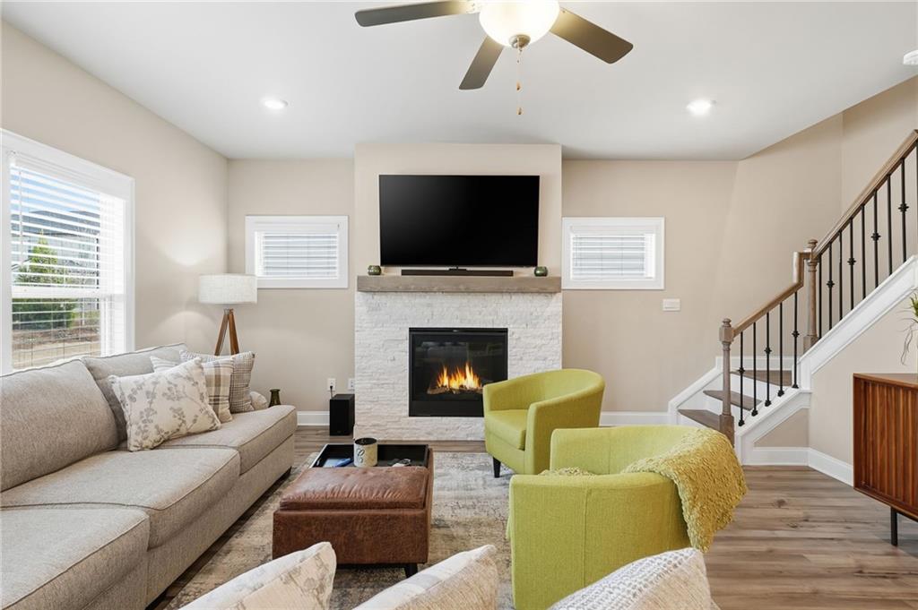 515 Cobblestone Circle Canton, GA 30115 - Photo 13 of 45 a living room with furniture a flat screen tv and a fireplace
