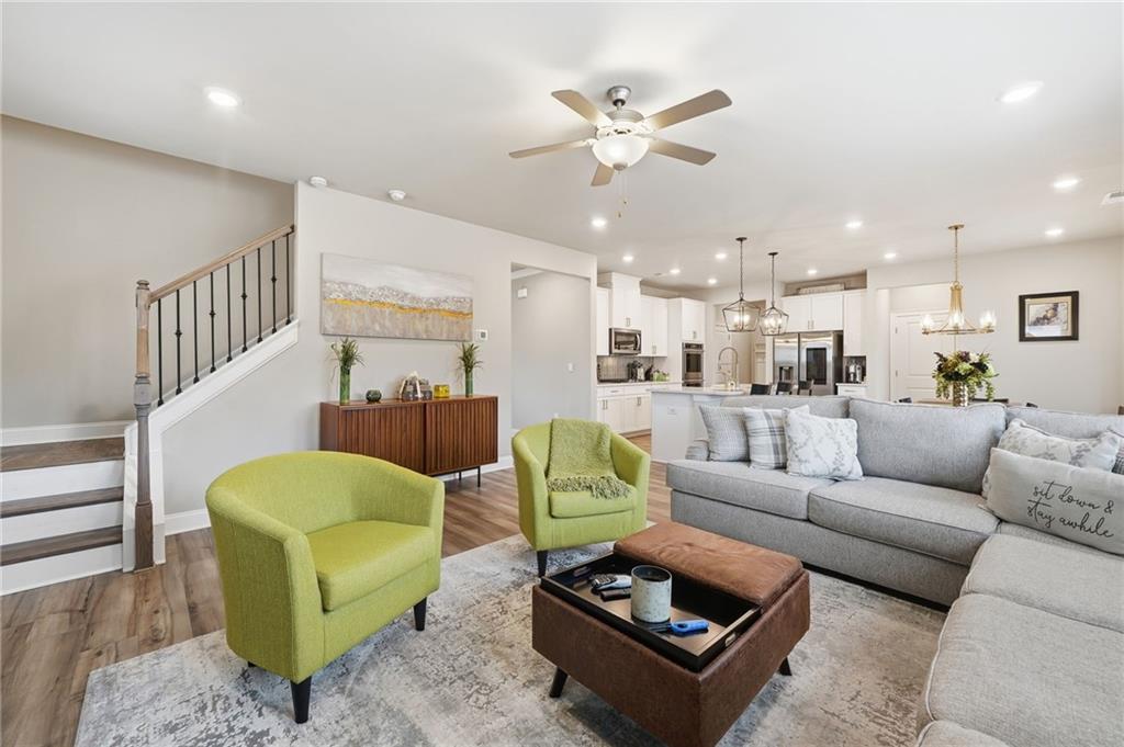 515 Cobblestone Circle Canton, GA 30115 - Photo 14 of 45 a living room with furniture kitchen view and a chandelier