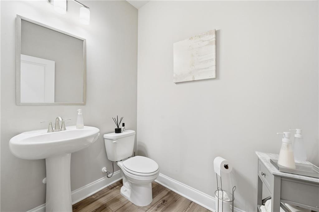 515 Cobblestone Circle Canton, GA 30115 - Photo 16 of 45 a bathroom with a toilet sink and mirror