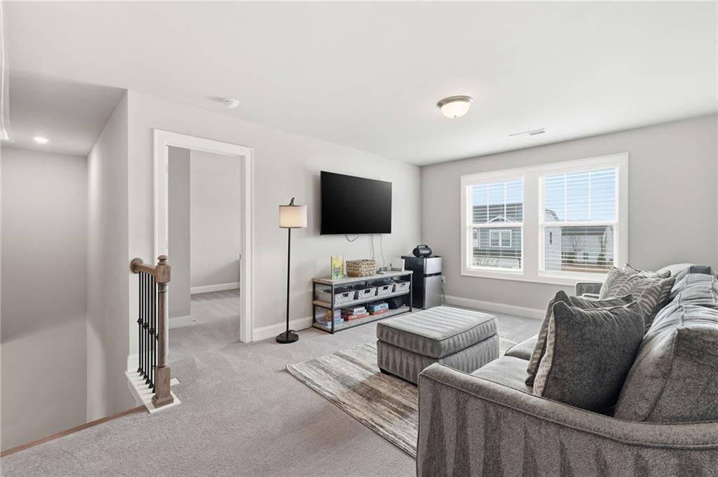 515 Cobblestone Circle Canton, GA 30115 - Photo 17 of 45 a living room with furniture and a flat screen tv