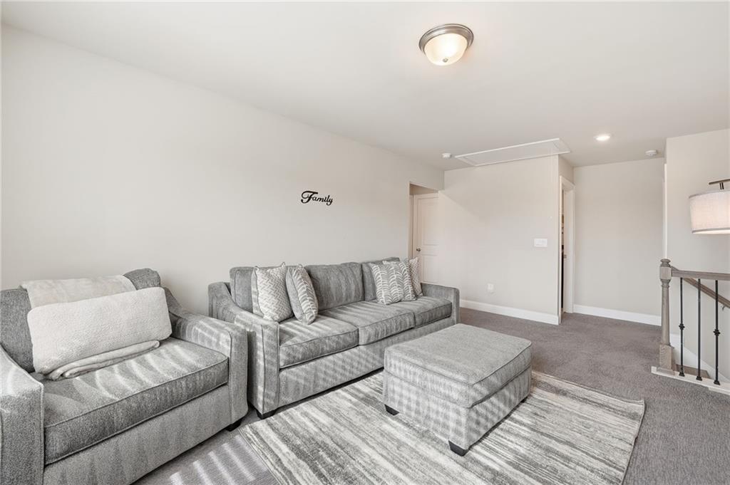 515 Cobblestone Circle Canton, GA 30115 - Photo 18 of 45 a living room with furniture and a rug