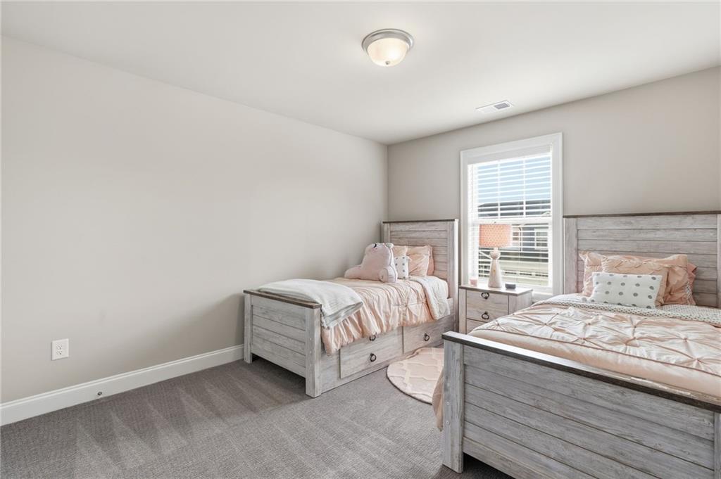 515 Cobblestone Circle Canton, GA 30115 - Photo 19 of 45 a bedroom with a bed and a window