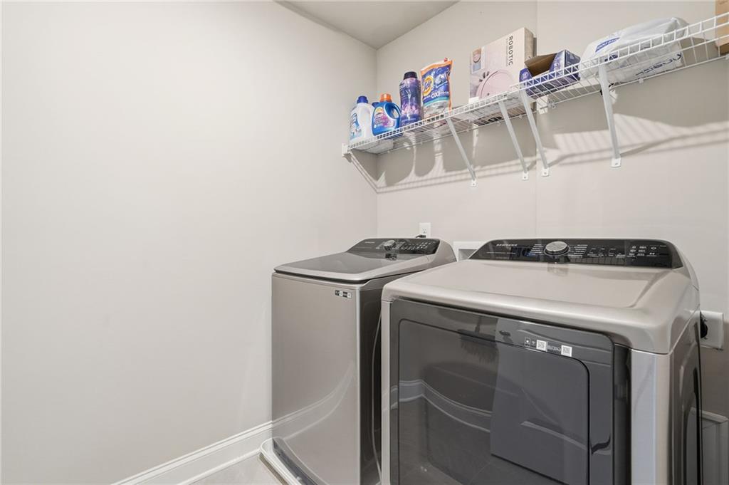 515 Cobblestone Circle Canton, GA 30115 - Photo 23 of 45 a utility room with dryer and washer
