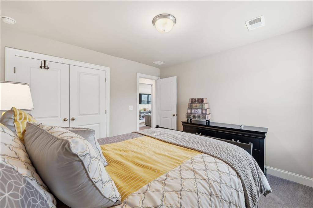 515 Cobblestone Circle Canton, GA 30115 - Photo 25 of 45 a bedroom with a bed and a lamp