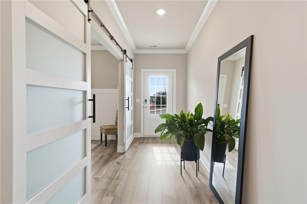 515 Cobblestone Circle Canton, GA 30115 - Photo 28 of 45 a view of a hallway with wooden floor and table and chairs