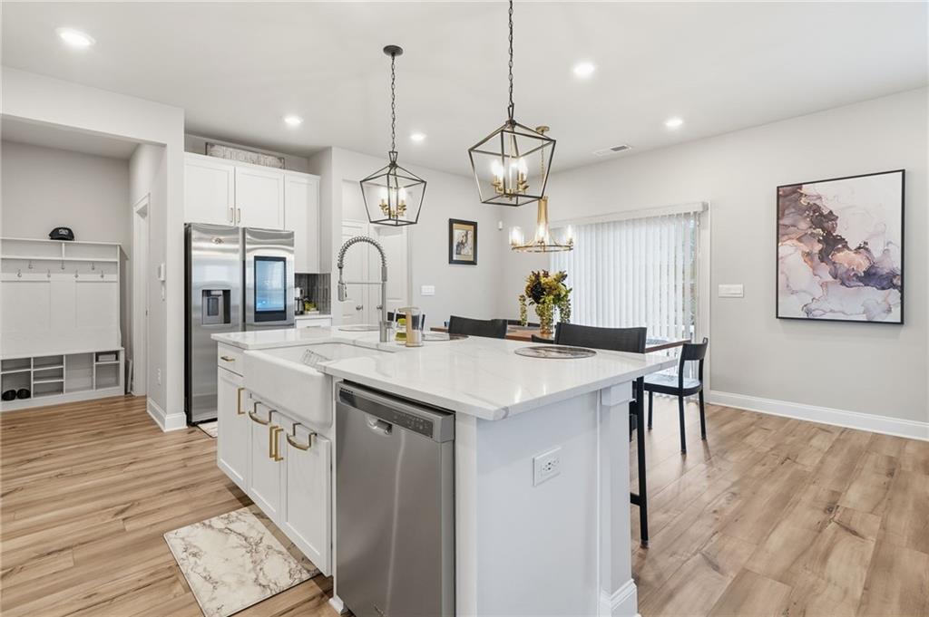 515 Cobblestone Circle Canton, GA 30115 - Photo 6 of 45 a large kitchen with granite countertop a large stove a sink dishwasher and a refrigerator with wooden floor