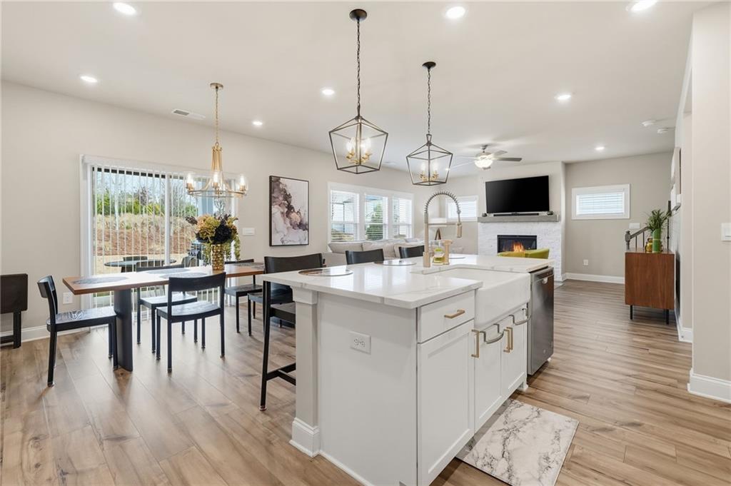 515 Cobblestone Circle Canton, GA 30115 - Photo 7 of 45 an open kitchen with wooden floor and stainless steel appliances