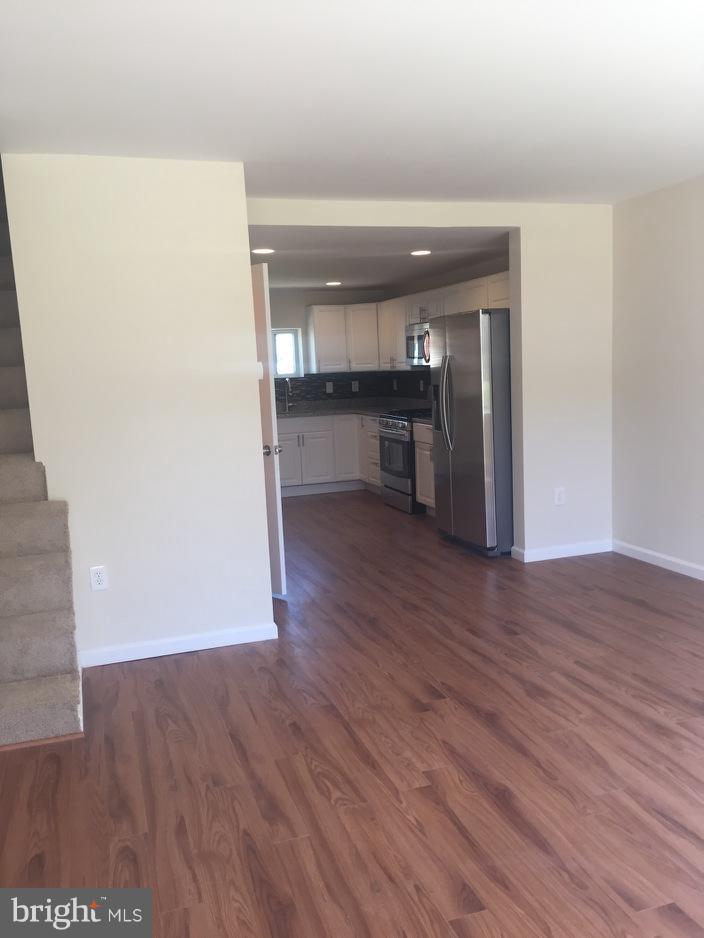 304 Arden Road West Baltimore, MD 21225 - Photo 27 of 30 a view of empty room with wooden floor