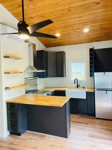 a kitchen with stainless steel appliances kitchen island sink stove and cabinets