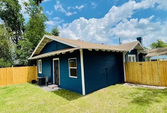 a view of a house with a backyard