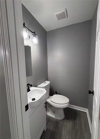 a white toilet sitting next to a bathroom sink