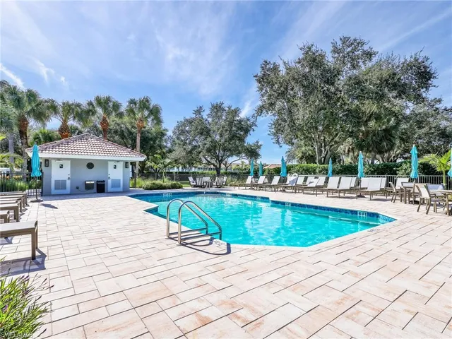 a view of a swimming pool with an outdoor space and seating area