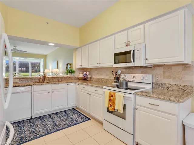 a kitchen with stainless steel appliances granite countertop a sink and cabinets