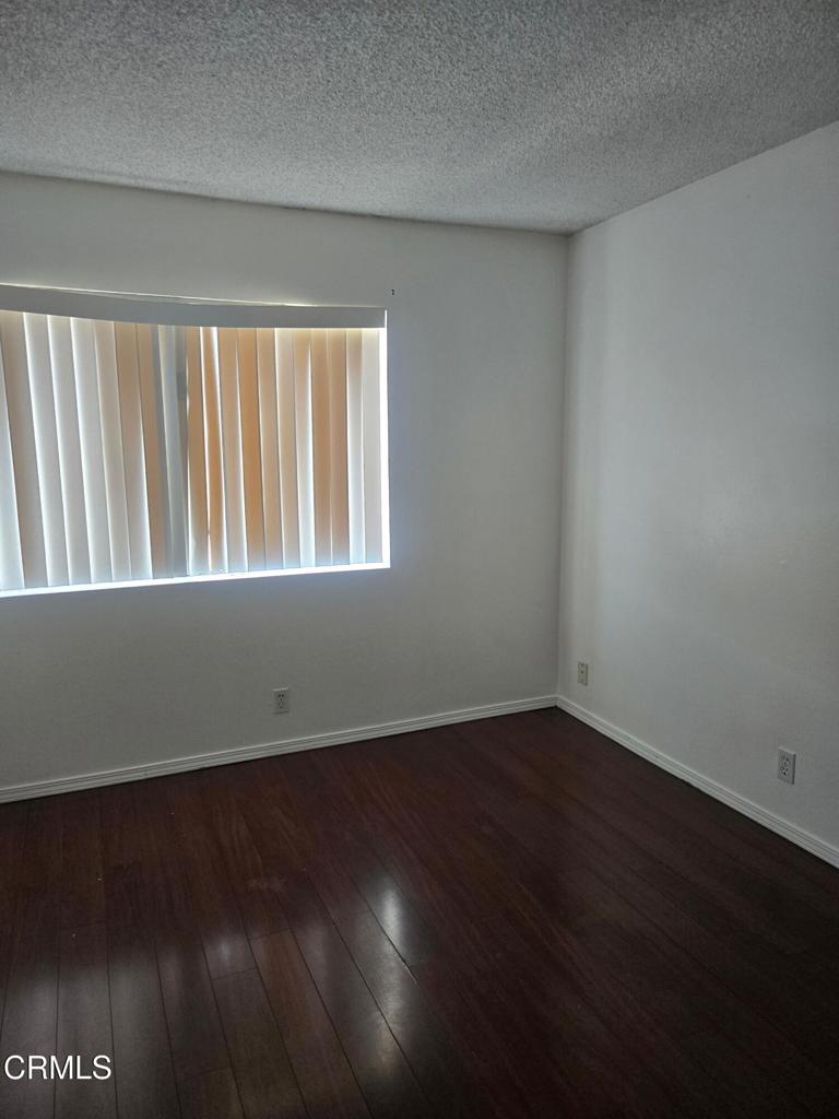 2065 East Bard Road Oxnard, CA 93033 - Photo 13 of 18 an empty room with wooden floor and windows