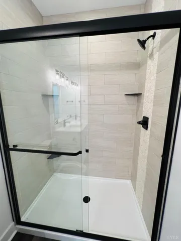 a bathroom with a glass shower door