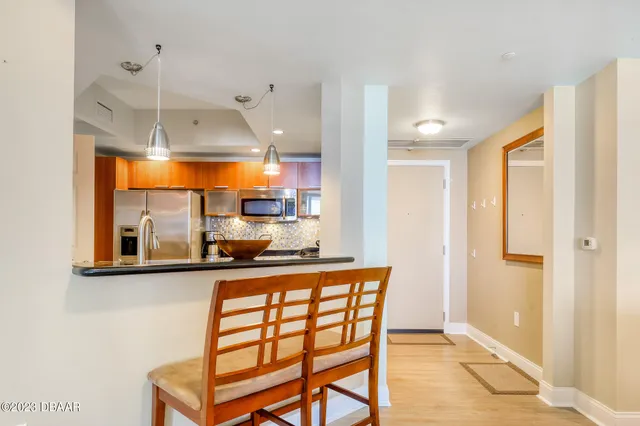 a kitchen with stainless steel appliances granite countertop a sink and a refrigerator