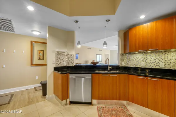a kitchen with stainless steel appliances granite countertop a sink and cabinets