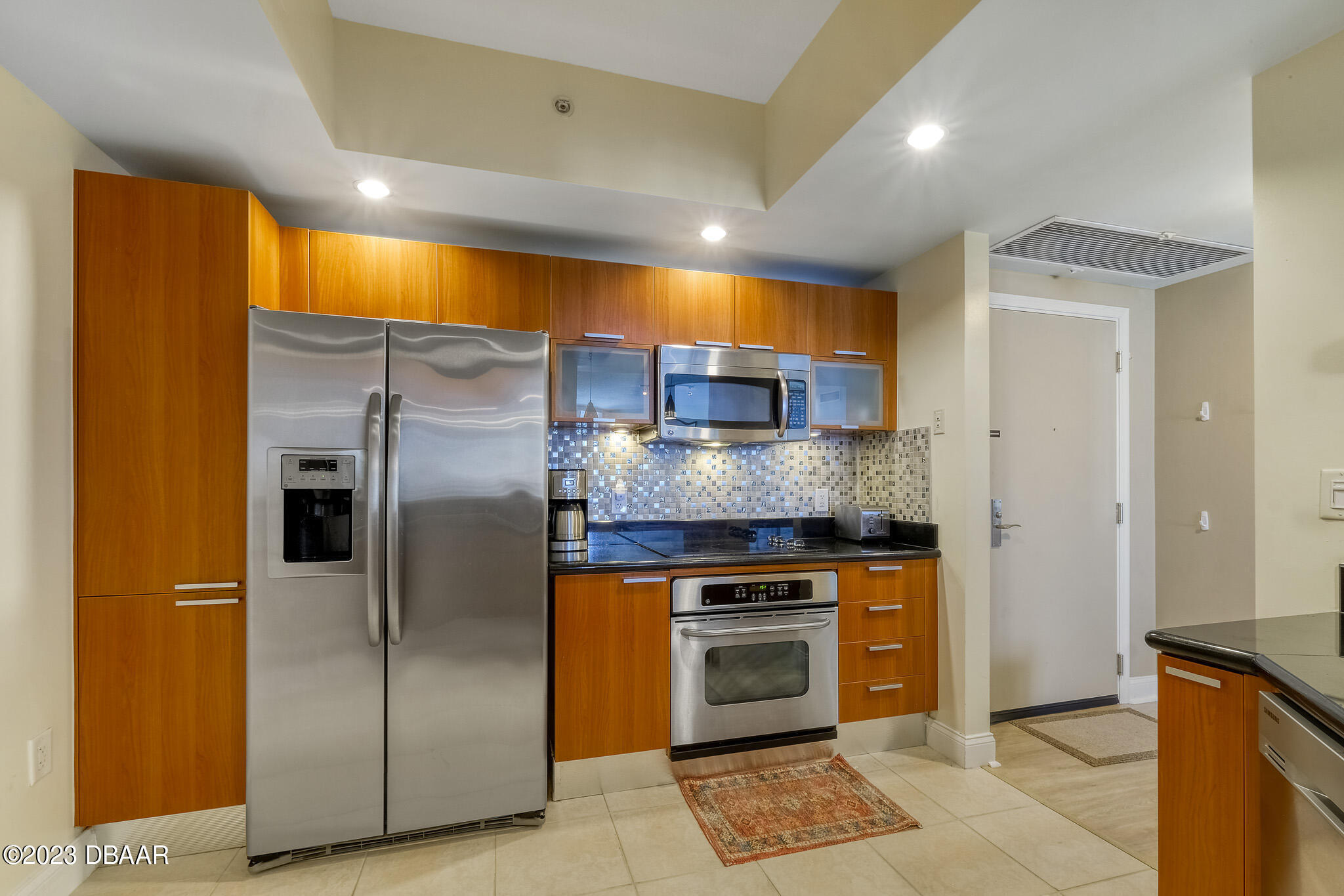 241 Riverside Drive, Unit 808 Holly Hill, FL 32117 - Photo 15 of 41 a kitchen with stainless steel appliances granite countertop a refrigerator a oven and a sink