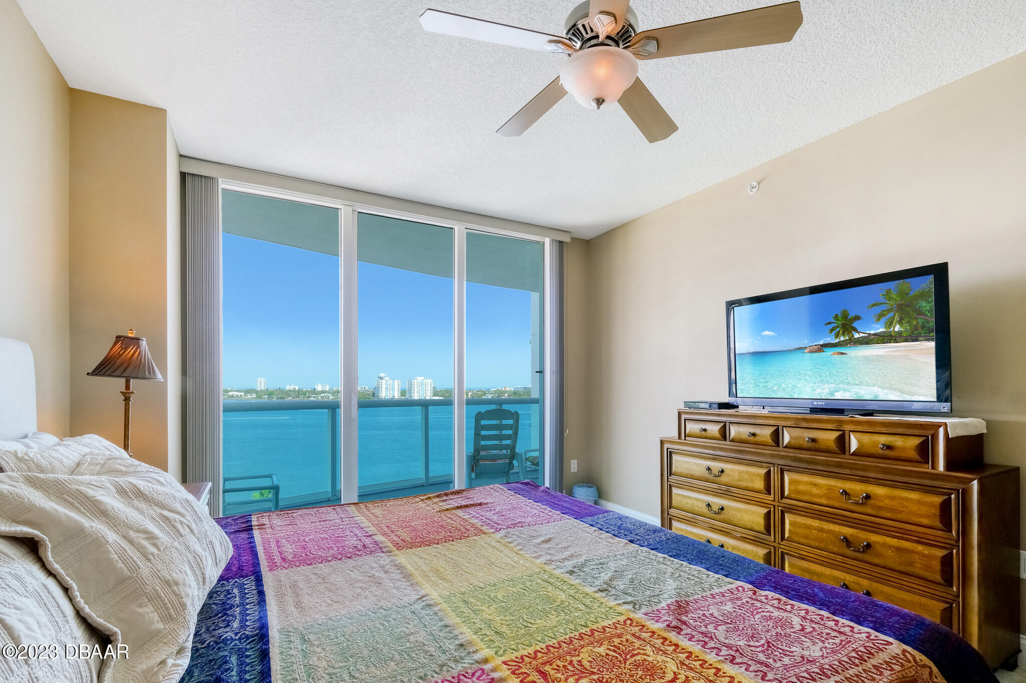 241 Riverside Drive, Unit 808 Holly Hill, FL 32117 - Photo 17 of 41 a bedroom with a bed and a flat screen tv