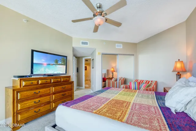 a bed room with a bed and a television