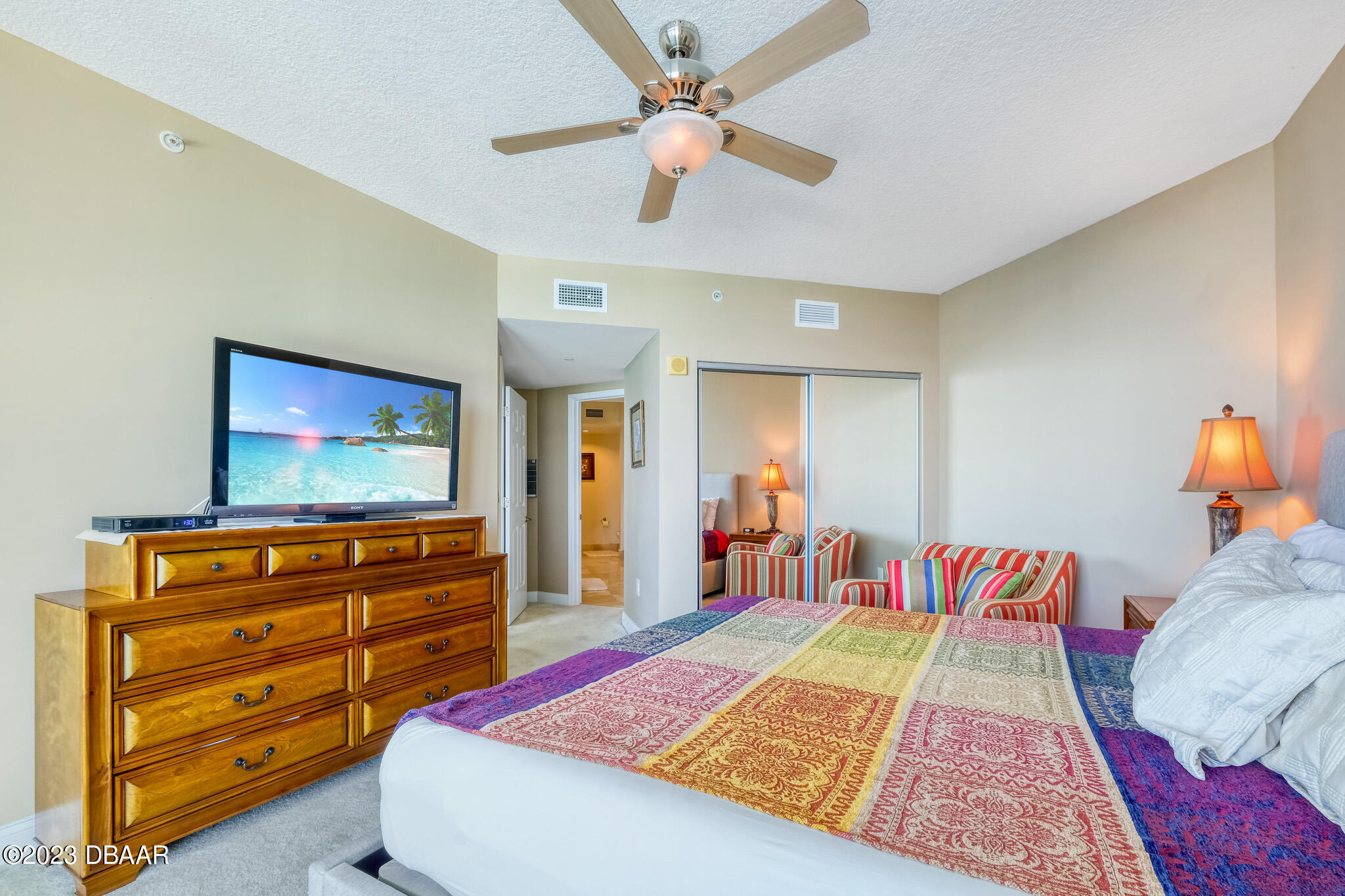 241 Riverside Drive, Unit 808 Holly Hill, FL 32117 - Photo 19 of 41 a bed room with a bed and a television