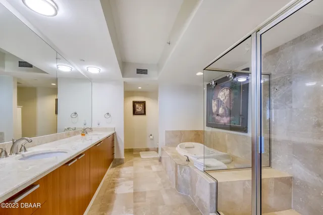 a bathroom with a tub a sink and mirror