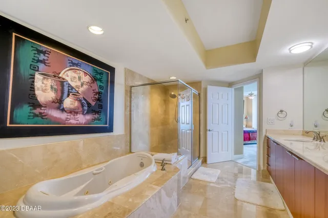 a spacious bathroom with a tub sink and mirror