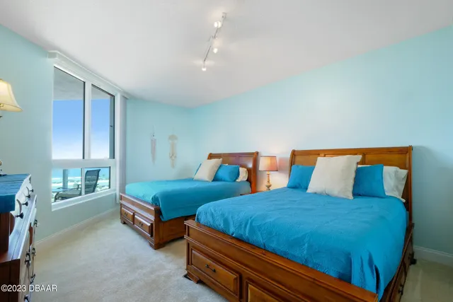 a bedroom with two beds and painted walls