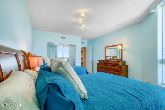 a bed room with a bed and a chandelier