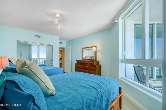 a bedroom with a large bed and a window