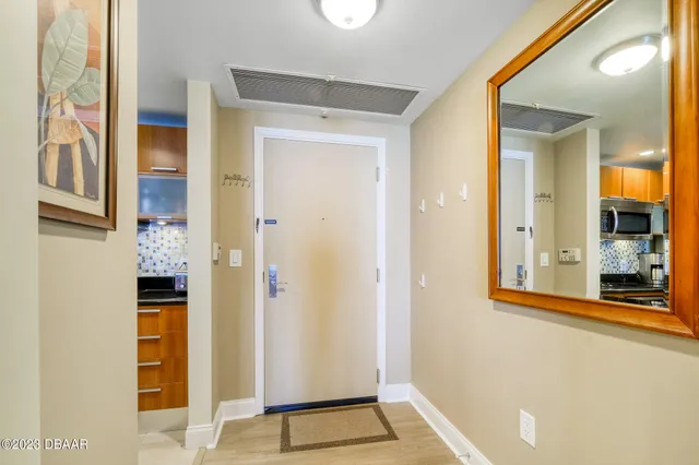 a view of a hallway with wooden floor and dining room
