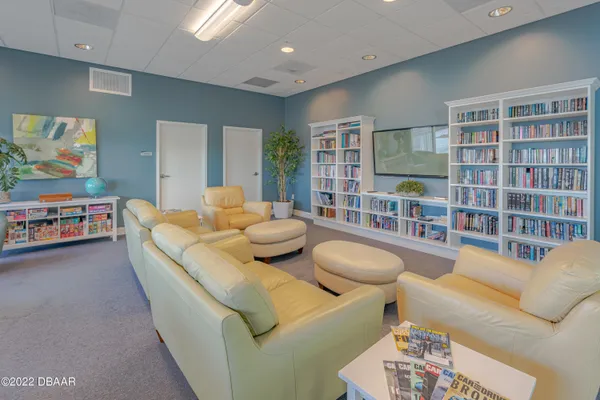a living room with furniture and a book shelf