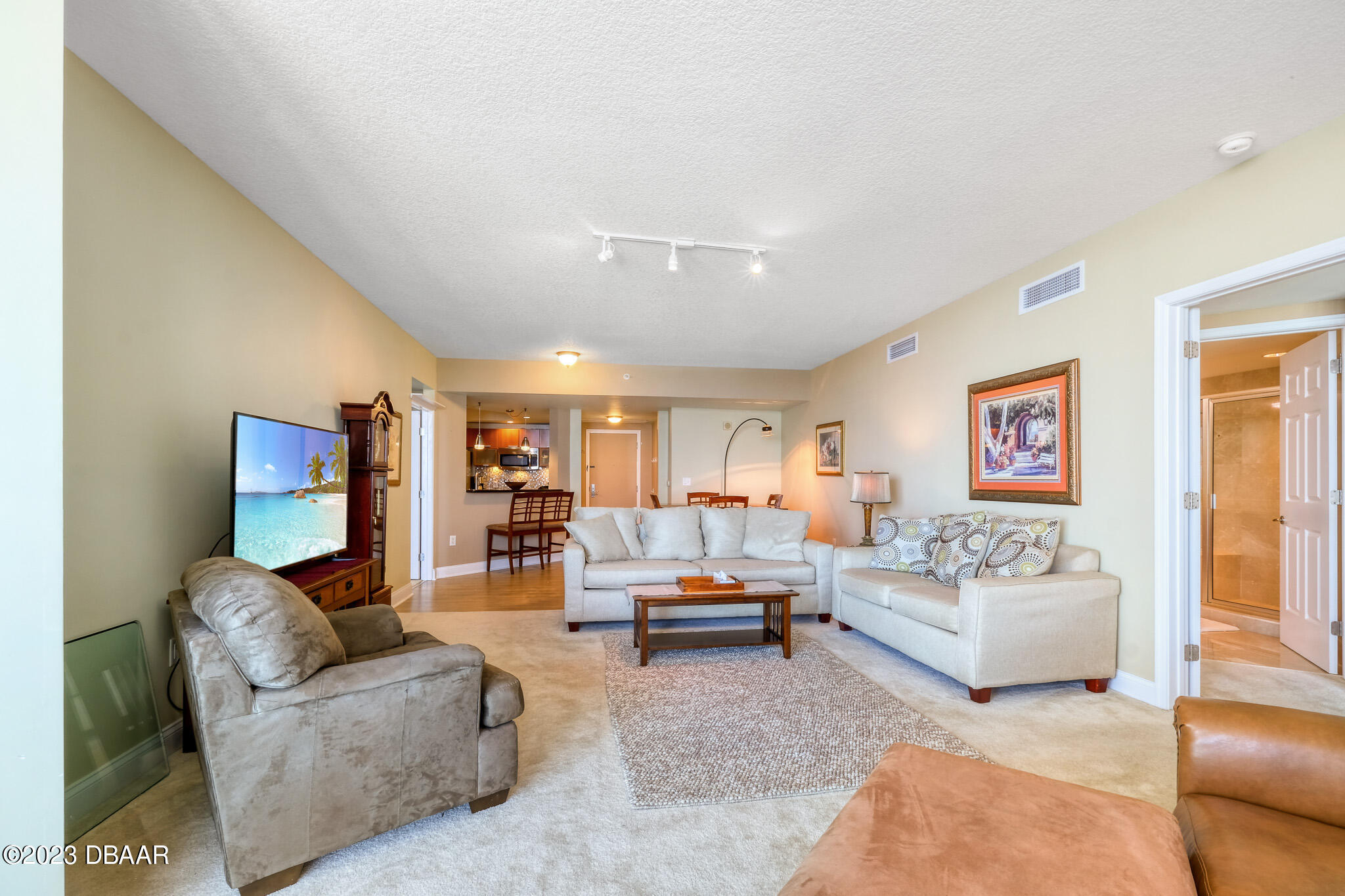 241 Riverside Drive, Unit 808 Holly Hill, FL 32117 - Photo 9 of 41 a living room with furniture and a flat screen tv