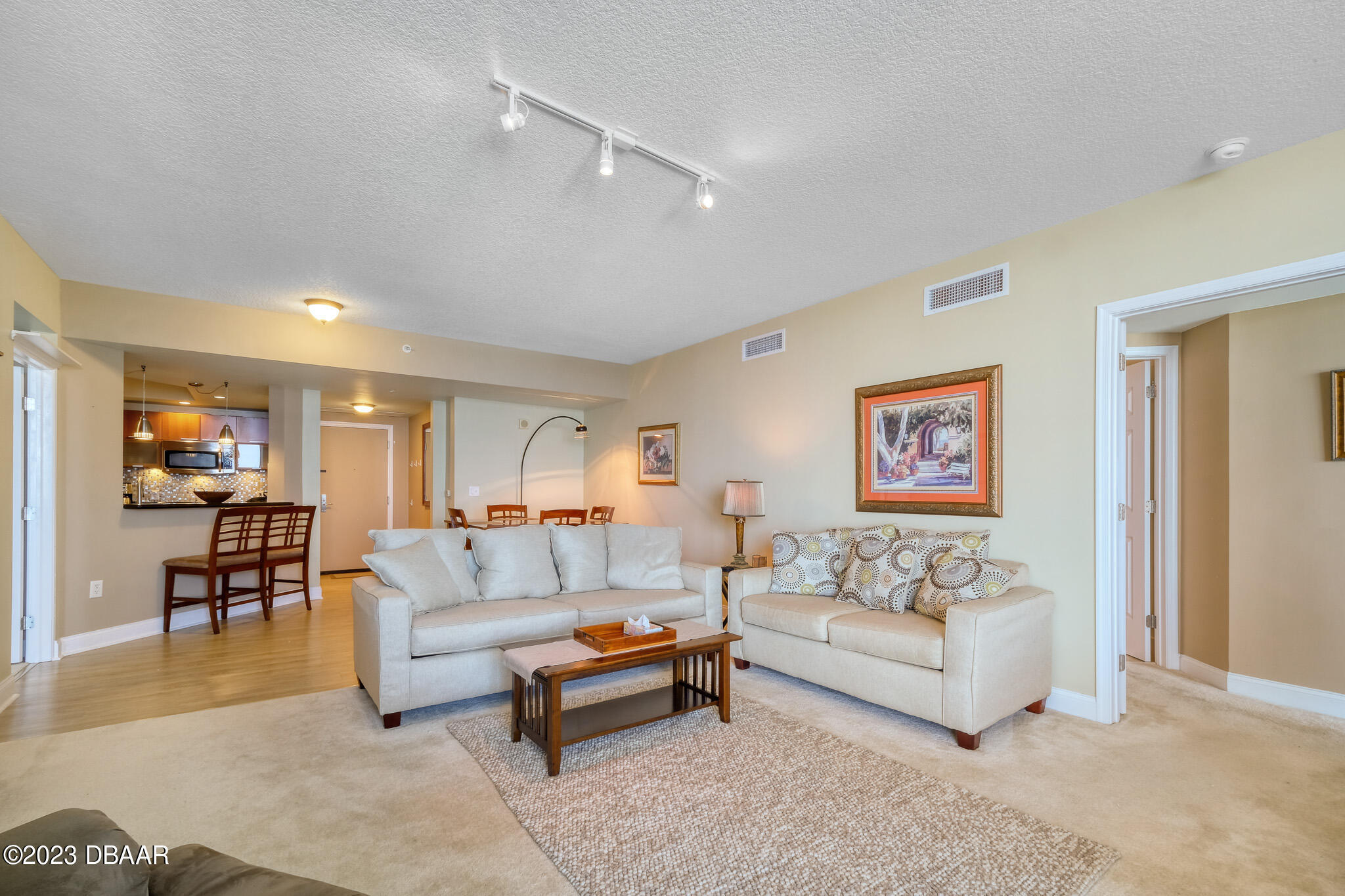 241 Riverside Drive, Unit 808 Holly Hill, FL 32117 - Photo 10 of 41 a living room with furniture and a dining table with wooden floor