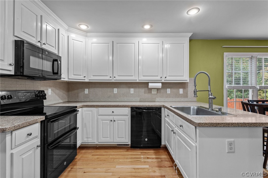 9437 Dunroming Road Chesterfield, VA 23832 - Photo 17 of 40 a kitchen with granite countertop a sink stove top oven and cabinets