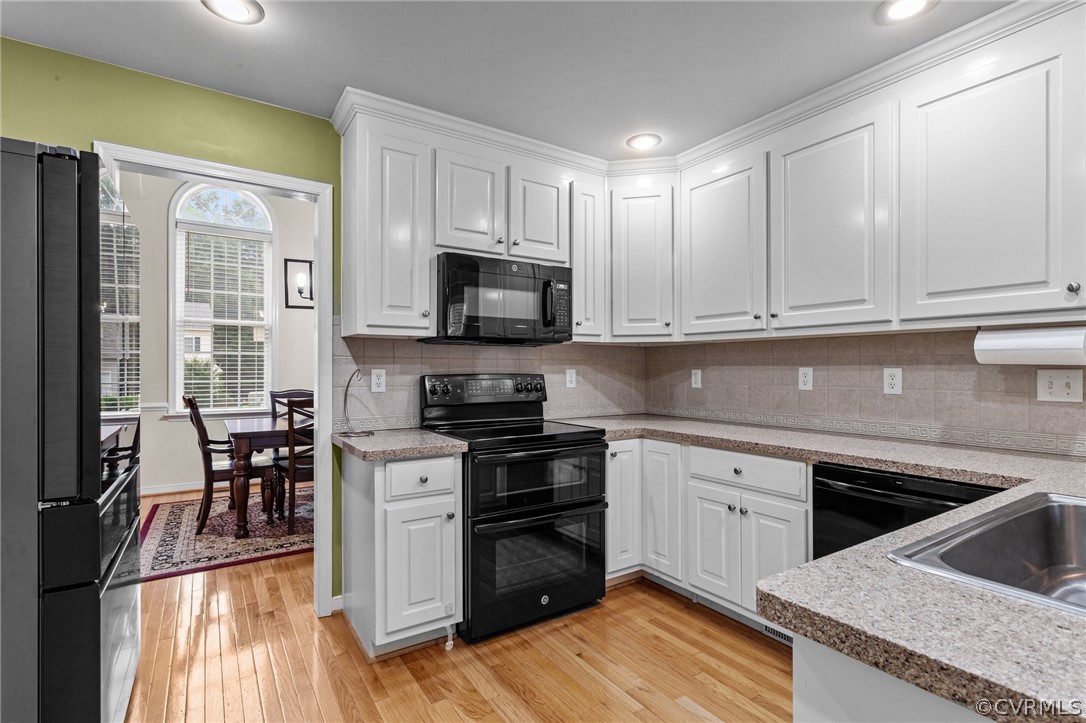 9437 Dunroming Road Chesterfield, VA 23832 - Photo 18 of 40 a kitchen with stainless steel appliances granite countertop a stove a sink and a microwave
