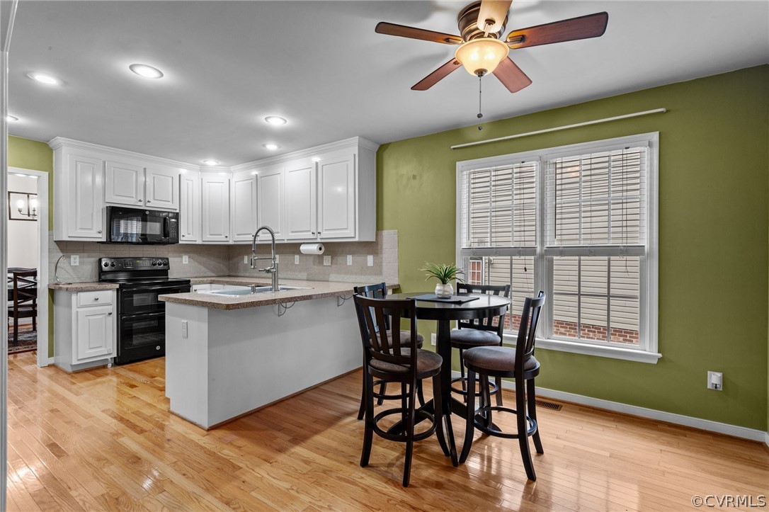 9437 Dunroming Road Chesterfield, VA 23832 - Photo 20 of 40 a kitchen with a table chairs sink and microwave
