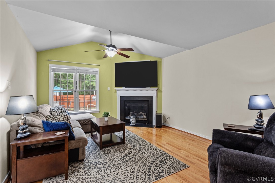 9437 Dunroming Road Chesterfield, VA 23832 - Photo 23 of 40 a living room with furniture a fireplace and a flat screen tv