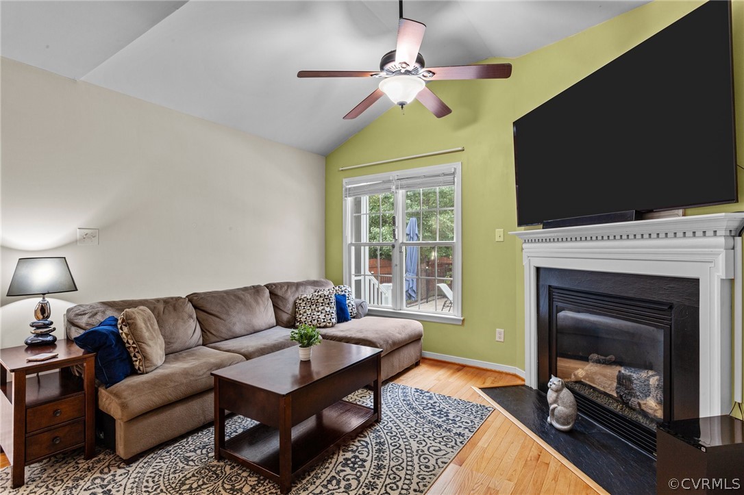 9437 Dunroming Road Chesterfield, VA 23832 - Photo 24 of 40 a living room with furniture a flat screen tv and a fireplace