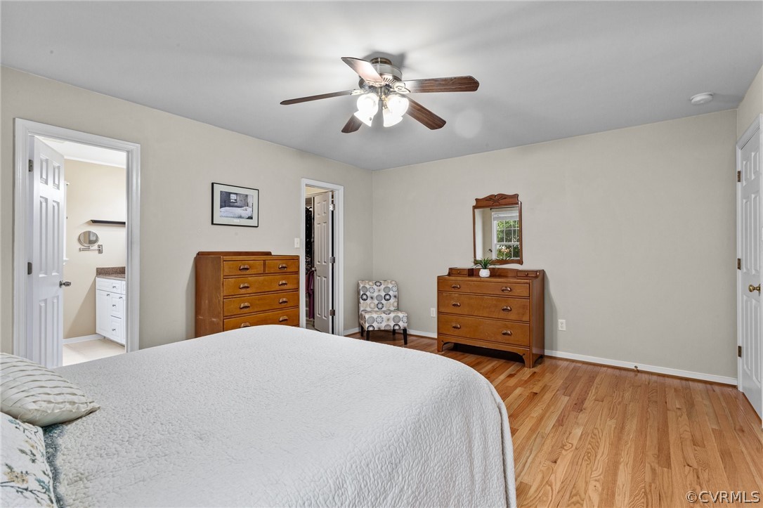 9437 Dunroming Road Chesterfield, VA 23832 - Photo 27 of 40 a bedroom with a large bed and a chandelier