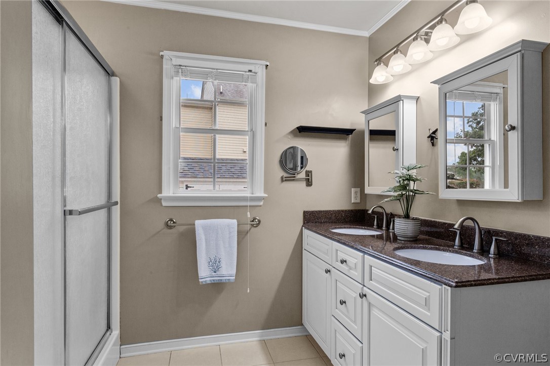 9437 Dunroming Road Chesterfield, VA 23832 - Photo 29 of 40 a bathroom with a double vanity sink and mirror with window