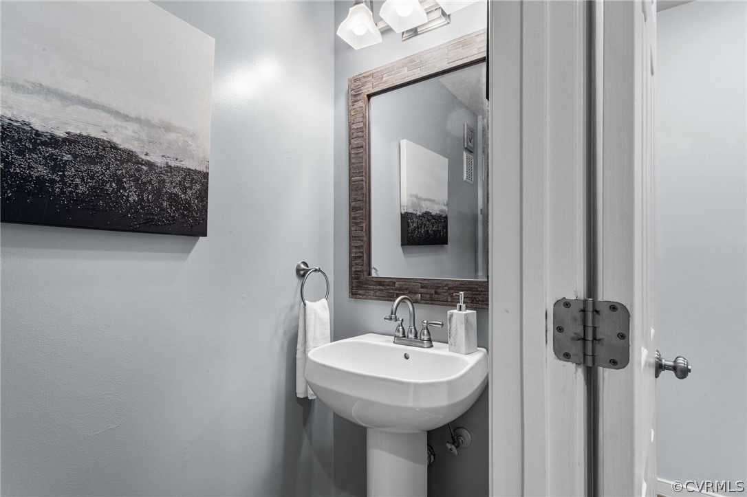 9437 Dunroming Road Chesterfield, VA 23832 - Photo 30 of 40 a bathroom with a sink and a mirror