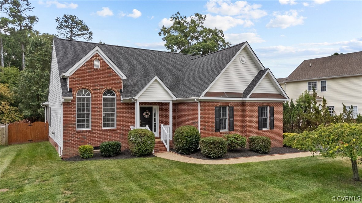 9437 Dunroming Road Chesterfield, VA 23832 - Photo 3 of 40 a view of a brick house with a yard plants and large tree